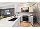 Modern kitchen with white cabinets, quartz countertops and black sink at 10650 E Tennessee Ave # 103, Aurora, CO 80012