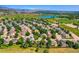 Wide aerial view of a residential neighborhood near a golf course and scenic water feature at 12534 W Hoover Ave, Littleton, CO 80127