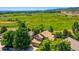 Aerial view of a home nestled among mature trees in a residential neighborhood at 12534 W Hoover Ave, Littleton, CO 80127