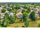 Aerial view showcasing a home with a fenced backyard and mature trees in a neighborhood at 12534 W Hoover Ave, Littleton, CO 80127