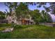 Backyard view showcasing a large lawn and deck with steps leading down to the yard at 12534 W Hoover Ave, Littleton, CO 80127