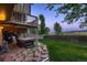 Large backyard featuring patio with hot tub and fenced yard at 12534 W Hoover Ave, Littleton, CO 80127