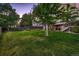 Spacious backyard with green lawn and deck, perfect for outdoor entertaining at 12534 W Hoover Ave, Littleton, CO 80127