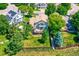 An aerial view of a spacious backyard with a large wooden deck, lush greenery, and a privacy fence at 12534 W Hoover Ave, Littleton, CO 80127