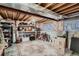 Unfinished basement storage space with exposed ceiling and organized shelving at 12534 W Hoover Ave, Littleton, CO 80127