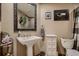 Bathroom featuring a pedestal sink, decorative mirror, toilet, and art at 12534 W Hoover Ave, Littleton, CO 80127