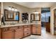 Bathroom featuring double sinks with granite countertops and updated cabinetry at 12534 W Hoover Ave, Littleton, CO 80127