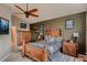 Bedroom showcasing a ceiling fan, large bed, and wooden dressers at 12534 W Hoover Ave, Littleton, CO 80127