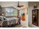 Bedroom showcasing a ceiling fan, large window, dresser, and comfortable bed at 12534 W Hoover Ave, Littleton, CO 80127