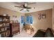 Cozy bedroom featuring hardwood floors, multiple windows, and a telescope at 12534 W Hoover Ave, Littleton, CO 80127