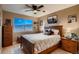 Bedroom with a bed, ceiling fan, large window, and a view at 12534 W Hoover Ave, Littleton, CO 80127