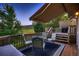 Outdoor deck area with comfortable seating, grill, and beautiful backyard views at 12534 W Hoover Ave, Littleton, CO 80127