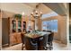 Elegant dining room with a chandelier, large wooden table, leather chairs, and a view of the outdoors at 12534 W Hoover Ave, Littleton, CO 80127