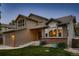 Well-kept home with a combination of brick and siding, complemented by lush green grass and professional landscaping at 12534 W Hoover Ave, Littleton, CO 80127