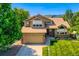 Charming two-story home with a well-manicured lawn and attached two car garage at 12534 W Hoover Ave, Littleton, CO 80127