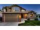 Attractive home featuring a brick and siding exterior, manicured lawn, and a welcoming entrance with steps at 12534 W Hoover Ave, Littleton, CO 80127