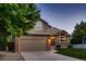 Charming two-story home with a brick and siding exterior, well-maintained lawn, and attached two-car garage at 12534 W Hoover Ave, Littleton, CO 80127