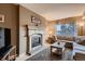 Cozy living room with a fireplace and a comfortable sofa at 12534 W Hoover Ave, Littleton, CO 80127