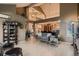 Open-concept living area with high ceilings, modern decor, wood floors, and a seamless flow into the dining space at 12534 W Hoover Ave, Littleton, CO 80127