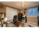 Cozy office with a large desk, comfortable chair, ample storage, and a window for natural light at 12534 W Hoover Ave, Littleton, CO 80127