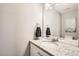 Bathroom featuring a granite countertop, white cabinets, and a large mirror at 202 Ash St, Bennett, CO 80102