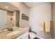 Clean bathroom featuring a shower and vanity with light grey walls and trim at 202 Ash St, Bennett, CO 80102