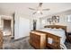Bedroom featuring a walk-in closet, a ceiling fan and ample natural light at 202 Ash St, Bennett, CO 80102