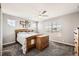 Bedroom with large window, ceiling fan, and wood furniture at 202 Ash St, Bennett, CO 80102