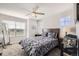 Cozy bedroom with a large window, ceiling fan, and comfortable bedding at 202 Ash St, Bennett, CO 80102