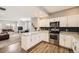 Well-designed kitchen with granite countertops, stainless steel appliances, and seamless flow to living area at 202 Ash St, Bennett, CO 80102