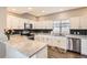 Updated kitchen with sleek stainless steel appliances, granite countertops, and a stylish backsplash at 202 Ash St, Bennett, CO 80102