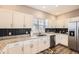 Modern kitchen featuring granite countertops, stainless steel appliances, and ample cabinet space at 202 Ash St, Bennett, CO 80102