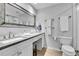 Bright bathroom featuring large mirror, white vanity, and natural-looking flooring at 45 Jackson St # C, Denver, CO 80206