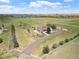 Wide aerial shot of the property showing the house, acreage, and surrounding scenery at 34771 E 153Rd Ct, Hudson, CO 80642