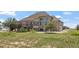 Expansive home exterior with large windows, a deck, and lush greenery at 34771 E 153Rd Ct, Hudson, CO 80642
