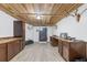 Basement room featuring wooden cabinets, wood ceiling, and hunting items at 34771 E 153Rd Ct, Hudson, CO 80642