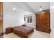 Bedroom with neutral carpet, single window, and a large wood wardrobe for storage at 34771 E 153Rd Ct, Hudson, CO 80642