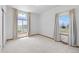 An open bedroom with large windows and neutral carpet and walls at 34771 E 153Rd Ct, Hudson, CO 80642