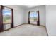 A simple bedroom with two windows letting in natural light and neutral walls at 34771 E 153Rd Ct, Hudson, CO 80642