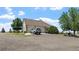 Exterior shot of a home with a circular driveway and attached garages at 34771 E 153Rd Ct, Hudson, CO 80642