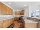 Well-lit kitchen features oak cabinetry, stainless steel appliances, and tile countertops at 34771 E 153Rd Ct, Hudson, CO 80642