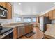 Spacious kitchen with stainless steel appliances, oak cabinetry, and plenty of natural light at 34771 E 153Rd Ct, Hudson, CO 80642