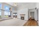 Bright living room boasts a fireplace, ceiling fan, and large windows for natural light and scenic views at 34771 E 153Rd Ct, Hudson, CO 80642