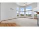 Expansive living room with vaulted ceilings and many windows offering panoramic views at 34771 E 153Rd Ct, Hudson, CO 80642