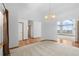 Open concept living room with hardwood floors and large windows for abundant natural light at 34771 E 153Rd Ct, Hudson, CO 80642