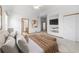 Bright main bedroom boasts an en suite bathroom, built-in media center, and a ceiling fan at 34771 E 153Rd Ct, Hudson, CO 80642