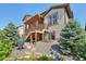 Beautiful backyard with a pergola-covered deck, grill, and lush landscaping at 18984 W 85Th Blf, Arvada, CO 80007
