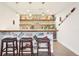 Finished bar with decorative license plates and a glass bar top for a unique basement entertainment space at 18984 W 85Th Blf, Arvada, CO 80007
