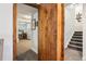 Basement entrance featuring a wooden doorway and view of the finished living space and stairway at 18984 W 85Th Blf, Arvada, CO 80007