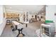 Spacious finished basement area featuring a custom bar, shuffleboard table, and comfortable seating at 18984 W 85Th Blf, Arvada, CO 80007